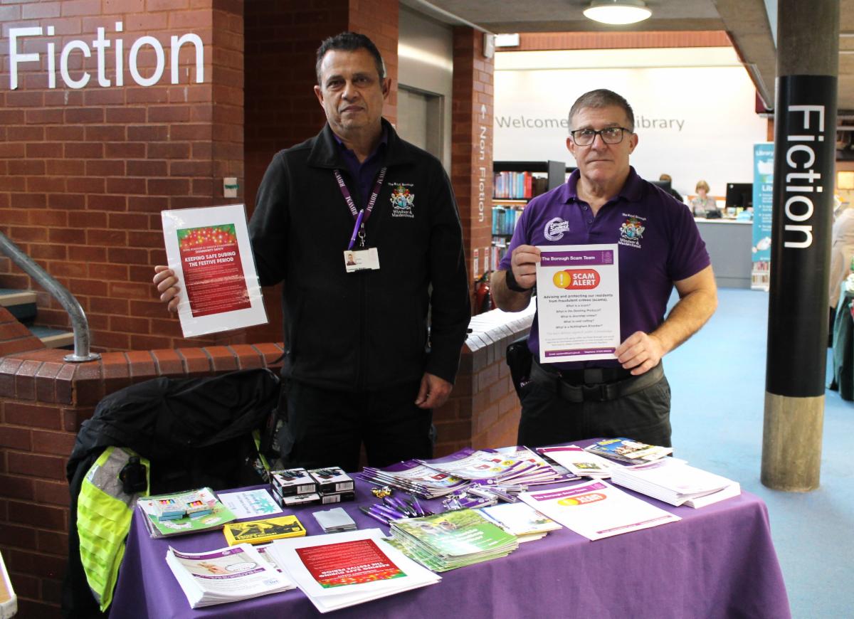 Two Royal Borough of Windsor and Maidenhead Community Wardens sharing information about anti-social behaviour and community safety at a table in Maidenhead Library